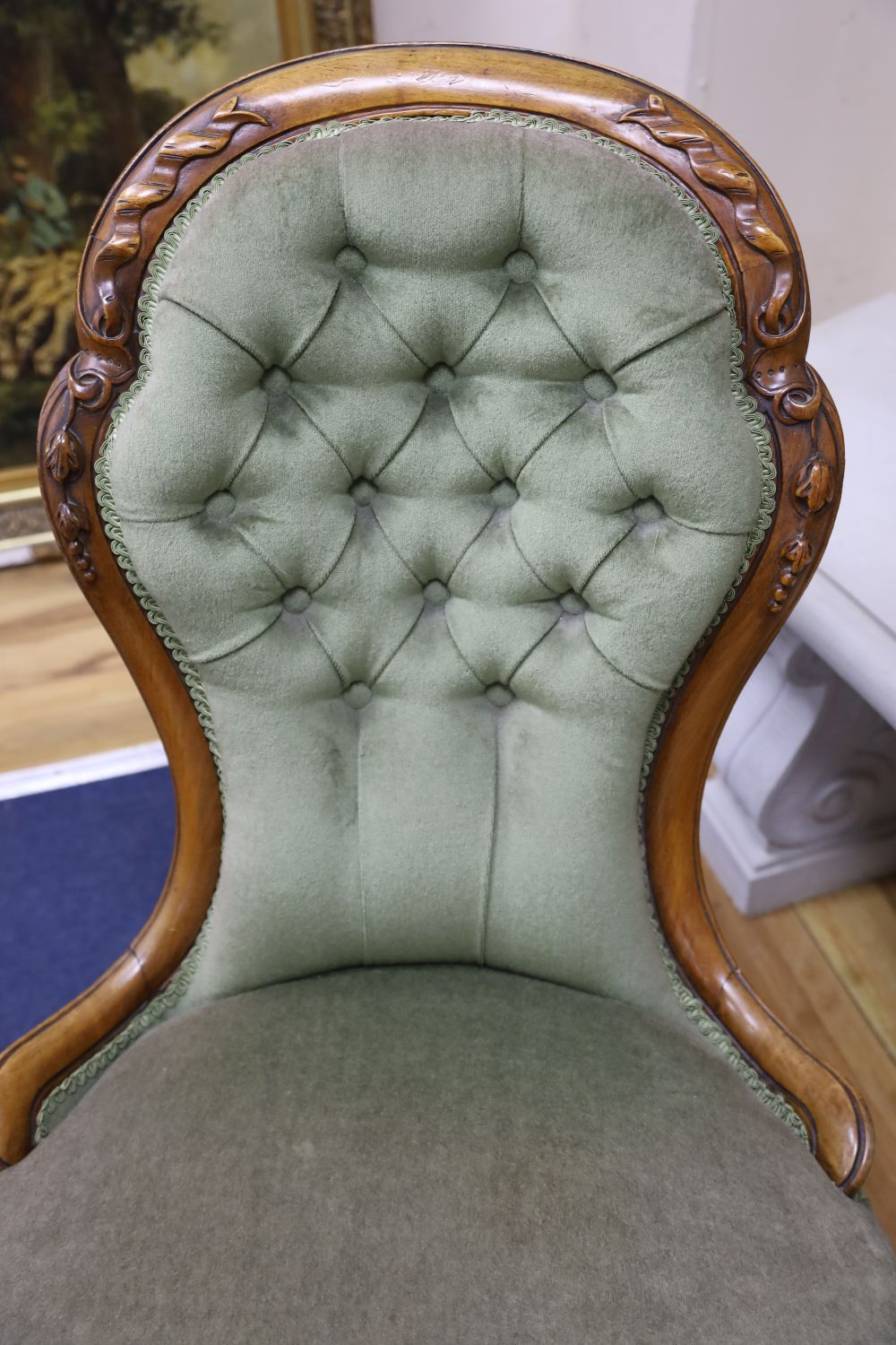 A Victorian carved walnut nursing chair